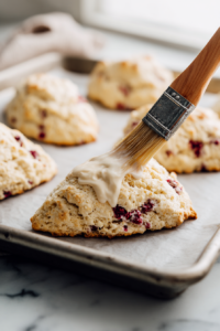 Whisk together the egg and milk for the egg wash, then brush over the tops of the scones.