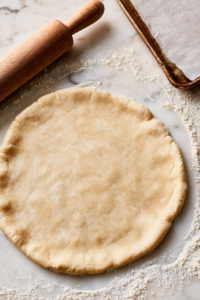 Roll the pie dough into a 12-inch circle on a lightly floured surface
