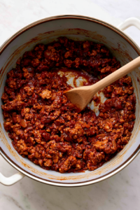 Add the tomato paste, chili powder, cumin, smoked paprika