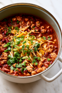 Pour in the crushed tomatoes, diced tomatoes, chicken broth