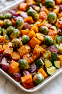 Toss the butternut squash, Brussels sprouts, zucchini, onion