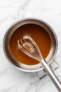 Pour the cooking liquid into a saucepan.