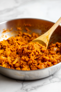 Mix in the red curry paste, turmeric, cumin,