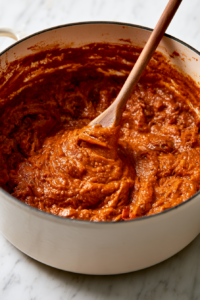 Mix in the tomato paste, chili powder, cumin
