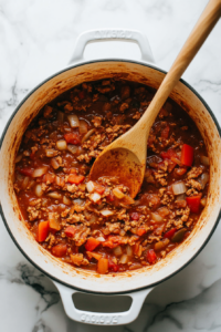 Mix in the tomato paste, chili powder, cumin